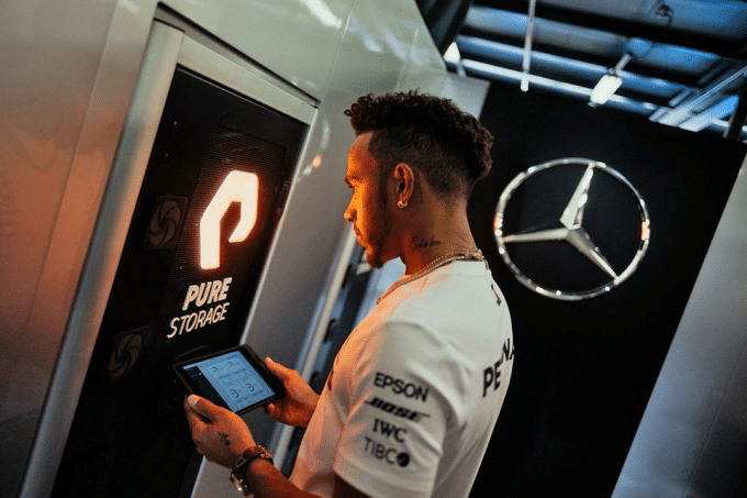 Lewis Hamilton next to PureStorage Logo Designed by Smithographic Logo & Brand Identity Studio, used by the F1 Mercedes AMG Petronas Team